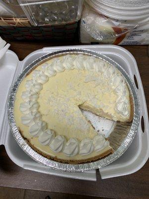 Key lime and coconut pie with a piece already on my co-workers plate.