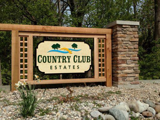 Sandblasted sign, cedar structure, and monument pillar all at one source.