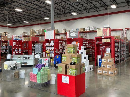 Rows of red shelving with janitorial supplies and carpet cleaning products at Jon-Don St. Louis