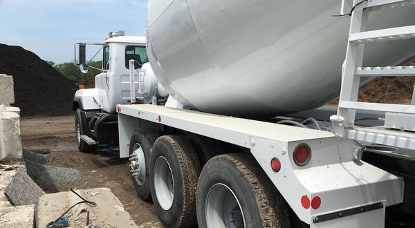 Rear discharge barrel truck