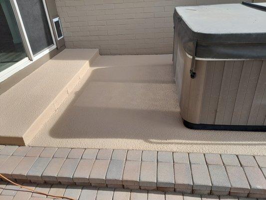 This photo shows new cool deck coating around an outdoor hot tub.