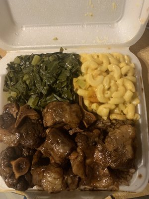 Oxtail platter with Mac and cheese and greens