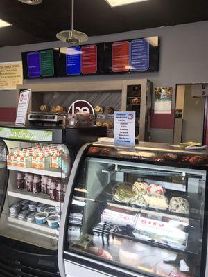 Store interior. Cream cheeses on the top shelf of the fridge.