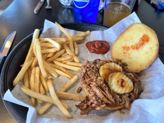 Pulled pork sandwich opened w/ sriracha pickles