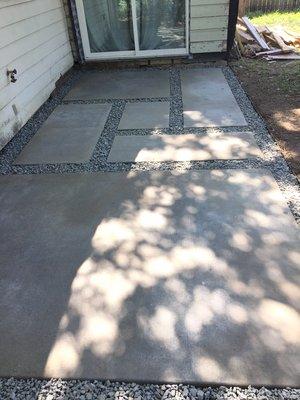 We added a concrete paver patio to a client's back yard. The larger slab is the entrance to a shed for motorcycles.