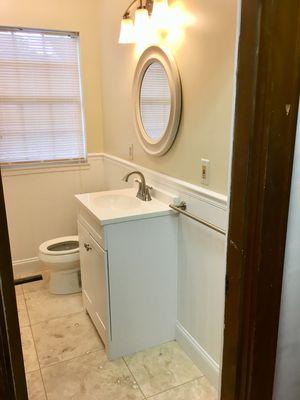 Bathroom remodel. New wainscoting, wall color and   18" x 18" floor tiles.