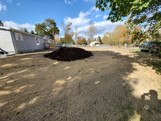 Spreading topsoil before seeding.