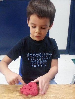 Playdough time with friends and teachers. Plenty of sensory play methods offered here as well.