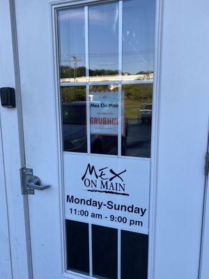 Front door showing business hours