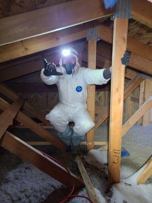 Crawling around in an attic addressing ventilation issues