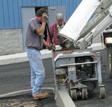 Machine extruded concrete curb in action. We can install up to 2,000 feet of concrete curb a day.