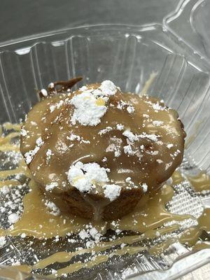 Made-from-scratch Praline Cornbread drizzled in praline sauce topped woth powdered sugar.