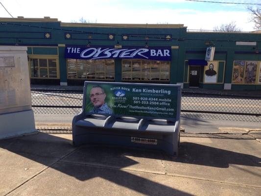 ThatRealtorKen@gmail.com  Bench sign in front of Spokes at Markham & Kavanaugh Boulevard, across from the legendary Oyster Bar.