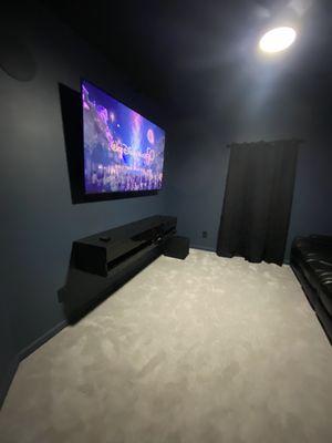 Complete theatre room, tv wall mounted, floating tv stand, ceiling fan, ceiling and wall speakers.