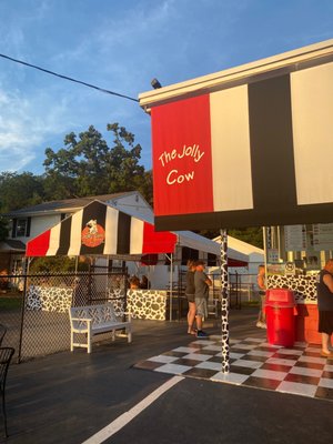 Covered seating area to the right of the Jolly Cow