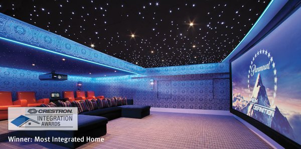 This theater features a 15-foot screen, a 7.2 surround-sound system, and an acoustical ceiling sparkling with fiber optic stars.