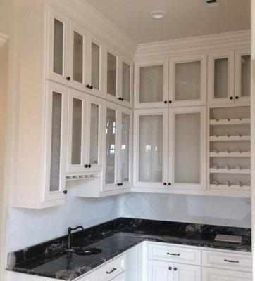 Kitchen cabinet with glass doors.