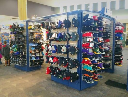 Lids kiosk in the middle of the mall.