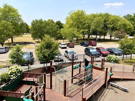 Parking lot next to playground and splash pad.