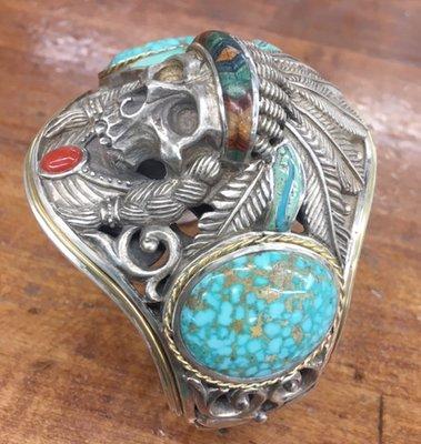 Custom sterling silver skull bracelet with turquoise and coral cabs and turquoise inlay.