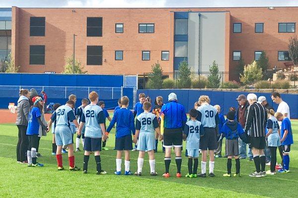 Middle School Soccer Team praying before a game