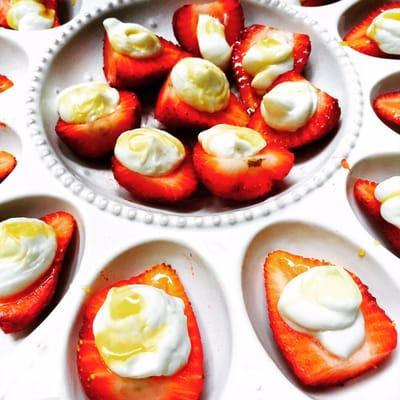 Strawberries with sweetened greek yogurt and white balsamic reduction.