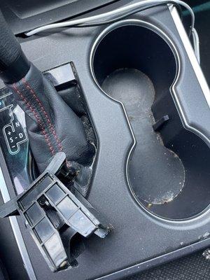 Cup holder divider was left off and gear shift has liquid puddles.. also not cleaned.