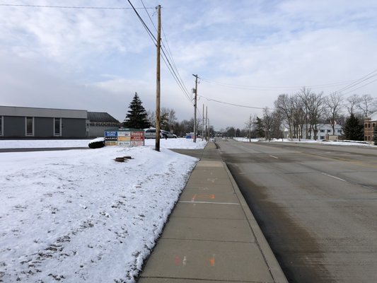 Wide-angle southbound view of our street sign and Allisonville Road. That driveway right behind the sign is where you turn in to find us!