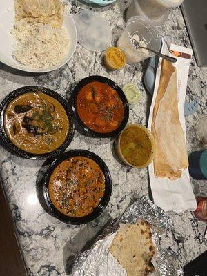 Guthi Vankaya (Eggplant), Butter Chicken Masala, Shrimp Vindaloo, Garlic Naan, Aloo (potato) Naan, and a dosa