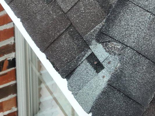 Damaged shingle and exposed nails.