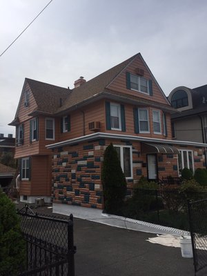 Exterior painting of siding and stones.