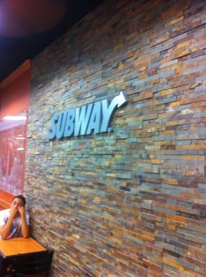 Brand spankin new Subway. Logo over stacked stone inside. Cool.