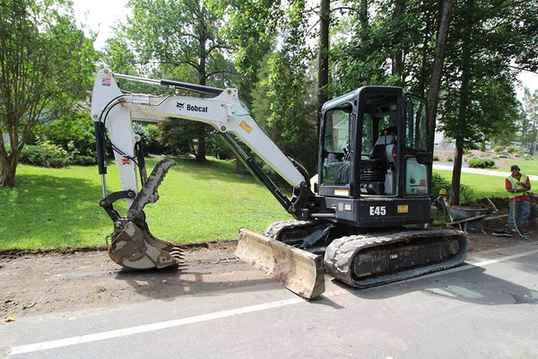 Sidewalk drainage system involving excavator work