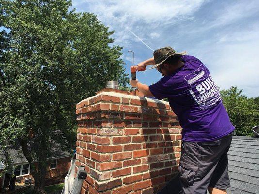 Logan prepping the crown before installing a new multi-flue cover. #317strong #bleedpurple www.cleansweep317.com