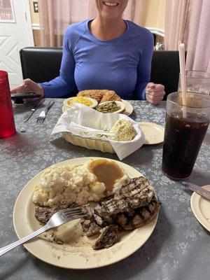 Grilled pork chop plate with Mac n cheese and mashed potato sides.