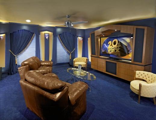 A large, unused room upstairs was transformed into an Art-Deco home theater, with LED lighting and custom wall treatments.