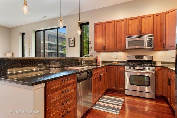 Kitchen before reno. Joel removed the outdated step in the countertop, the old cabinets and lighting and installed new cabinets.