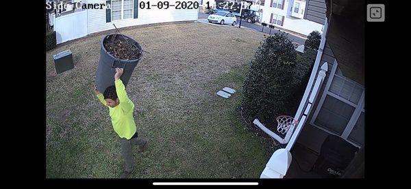 Employee walking with 55 gallon garbage container which they dumped behind our house instead of the work truck steps away.