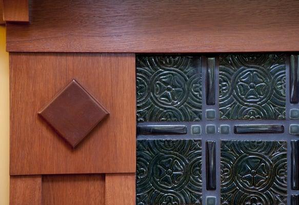 Corner detail mahogany fireplace surround. Tile is vintage recycled British Arts & Crafts style ceramic.