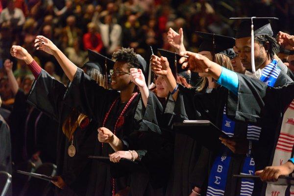 Students giving a "toast to Carolina" during graduation.