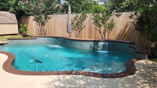 Previous tile removed and replaced with glass block.  Old brick coping removed, new coping added with a pool finish that looks amazing!