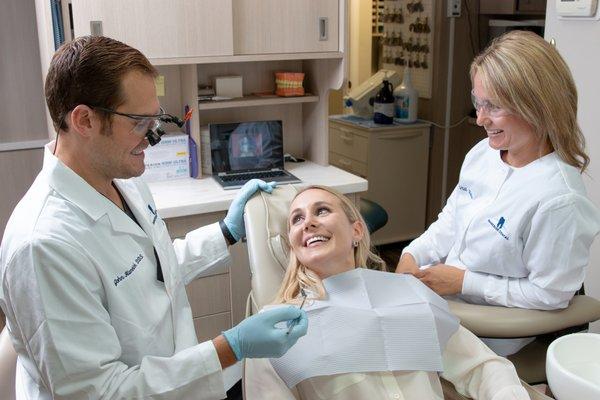 Dr. John & hygienist, Anna, going over examination with patient