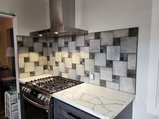 Tile and countertop for stove area. Before finished electrical.