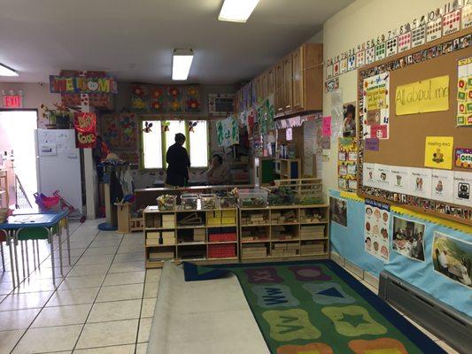 The area in the back is where toddlers are. The area towards the front w/ bulletin board is where they have older kids 4+.