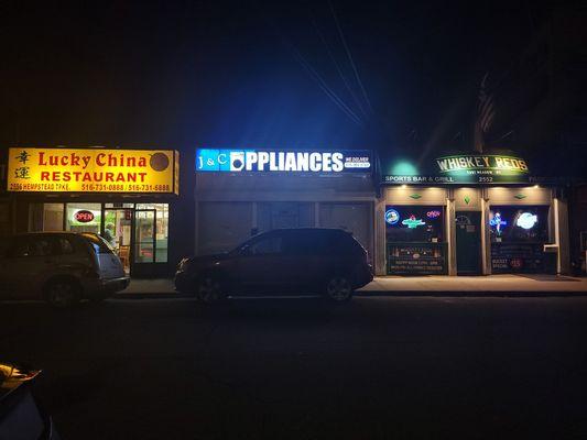 Storefront at night. Hempstead Turnpike East Meadow.