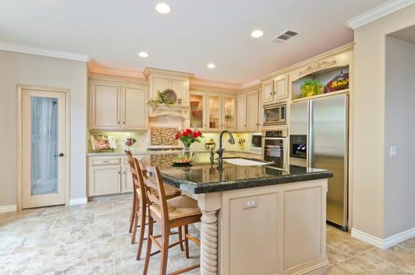 After, kitchen cabinets that were originally dark in color, now have a light and fresh look