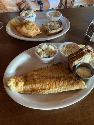 Seafood stuffed salmon with potato salad top plate. Pan fried walleye and potato salad bottom plate.