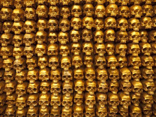 Gold-leafed human skull replicas created by Kihl Studios cover the walls of the Gold Bar in NYC