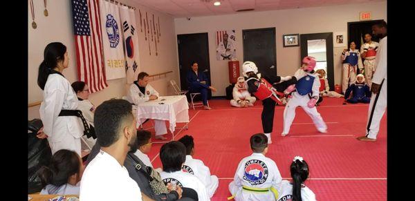 Owner/Master Chris Malarkey center refereeing with Owner Grandmaster Mark Nathanson head judging (seated at table).