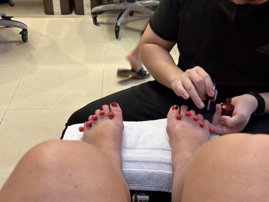 Anthony paints my toe nails.